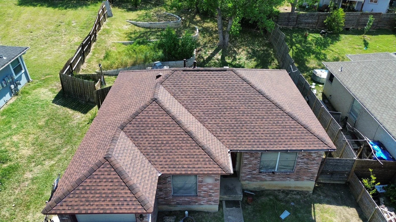 Completed roof replacement in Austin, Texas using GAF Timberline HDZ shingles in Hickory, photographed from above
