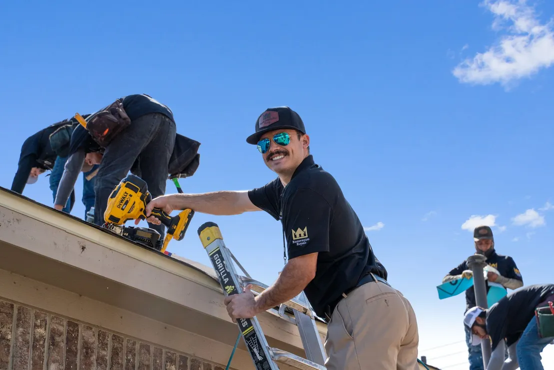 Roof Royale crew member on the job with team installing a roof