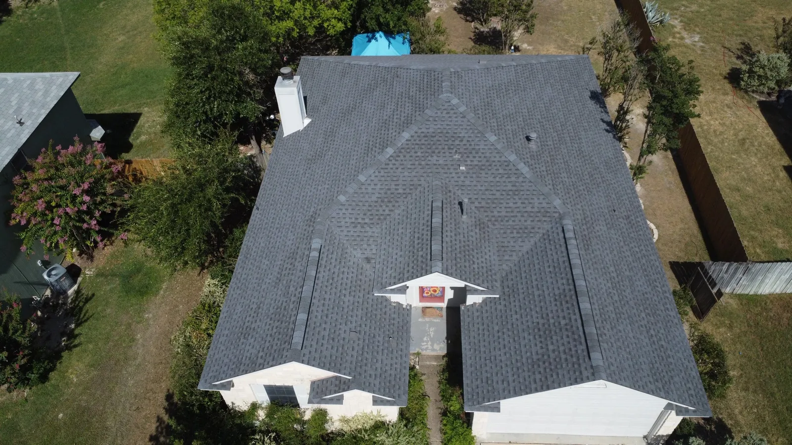 Completed roof replacement in Hutto, Texas using GAF Timberline HDZ shingles in Pewter Gray, photographed from above