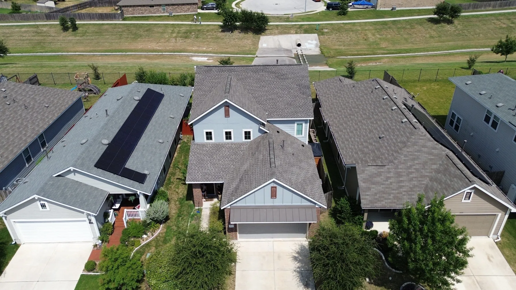 Completed roof replacement in Round Rock, Texas, GAF Timberline HDZ in Weatherwood, photographed from above