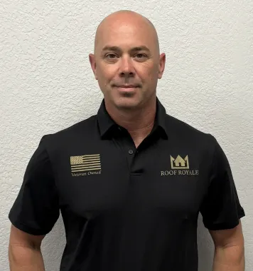 Blaine W. in a Roof Royale polo against a wall