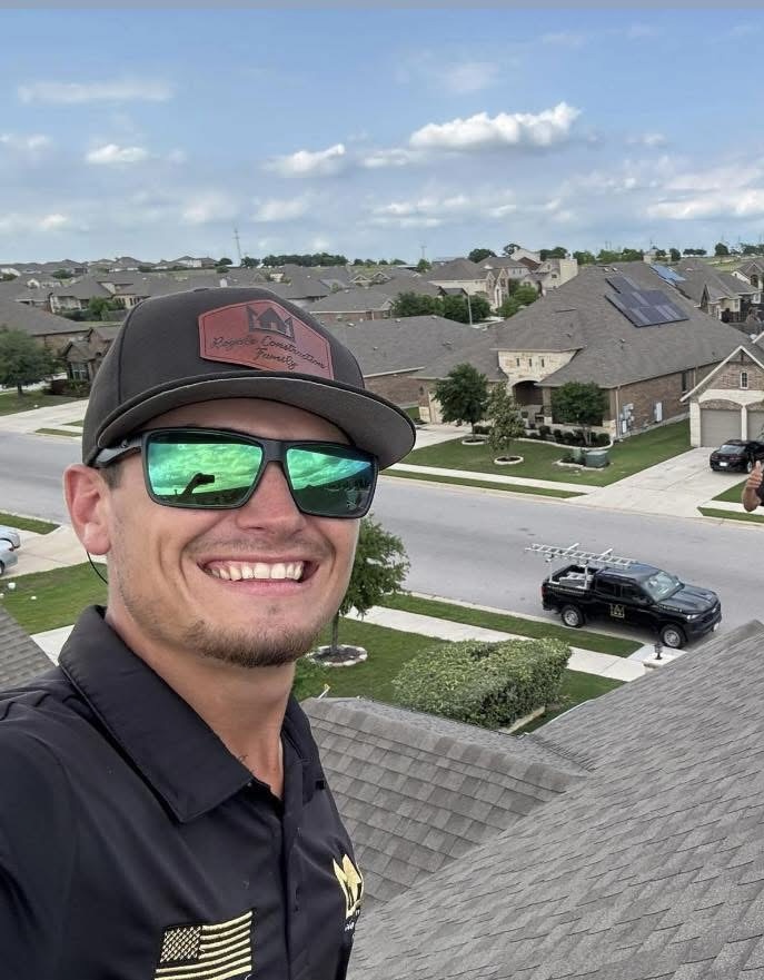 Cooper P. on a residential roof wearing green sunglasses