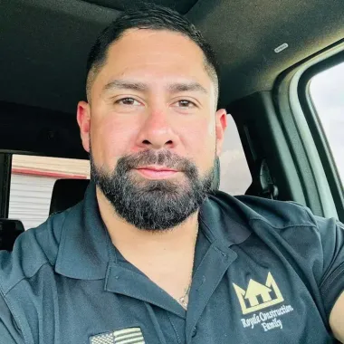 Cruz M. inside a vehicle wearing a Roof Royale polo