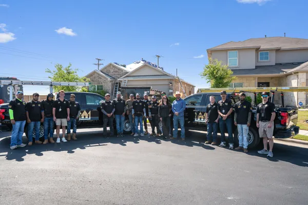 Roof Royale veteran-owned roofing team standing with company trucks